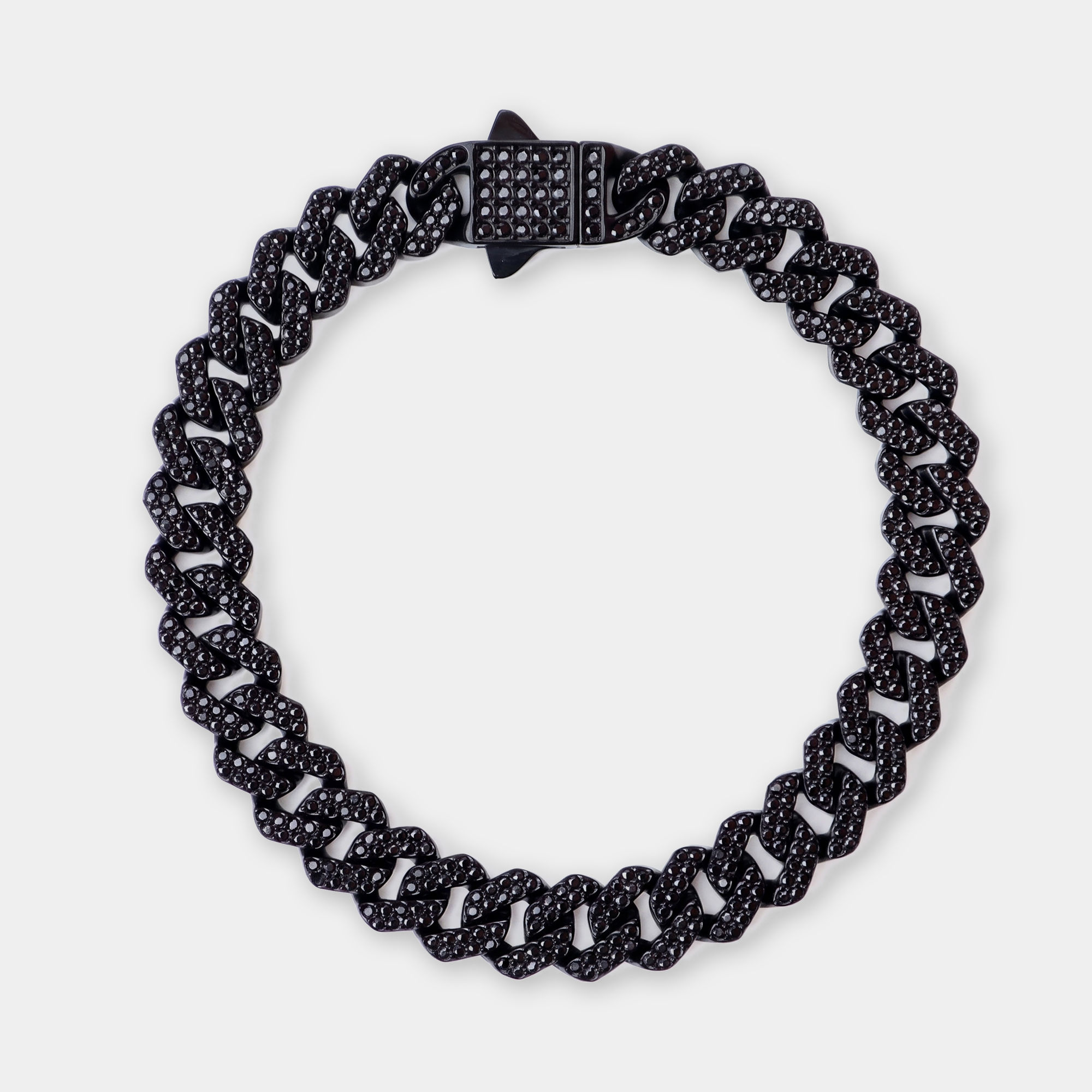A black chain link bracelet with a star-shaped clasp, photographed on a light gray background.